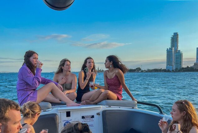 Open bar sunset party in the bay sharing with natives